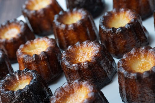 Caneles de bordeaux, traditional French sweet dessert with white table background, High quality photo