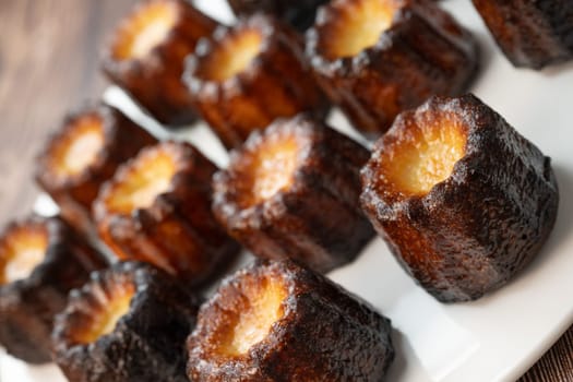 Caneles de bordeaux, traditional French sweet dessert with white table background, High quality photo