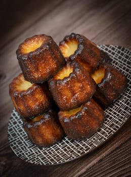 Caneles de bordeaux, traditional French sweet dessert with white table background, High quality photo