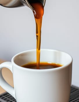 Warm, aromatic coffee flows smoothly into a clean, white mug. The setting is a cozy cafe, highlighting the start of a relaxing morning.
