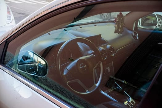 Cremona, Itally - October 6th 2024 Silver opel insignia parked with a view of its interior through the window, featuring the steering wheel and dashboard