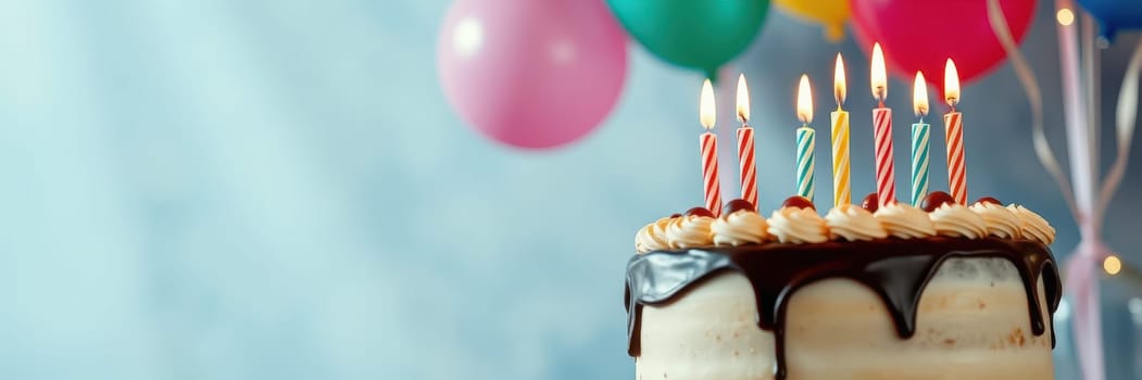 A beautifully decorated birthday cake sits on a table, adorned with colorful candles. Vibrant balloons float in the background, creating a joyful atmosphere for a celebration.