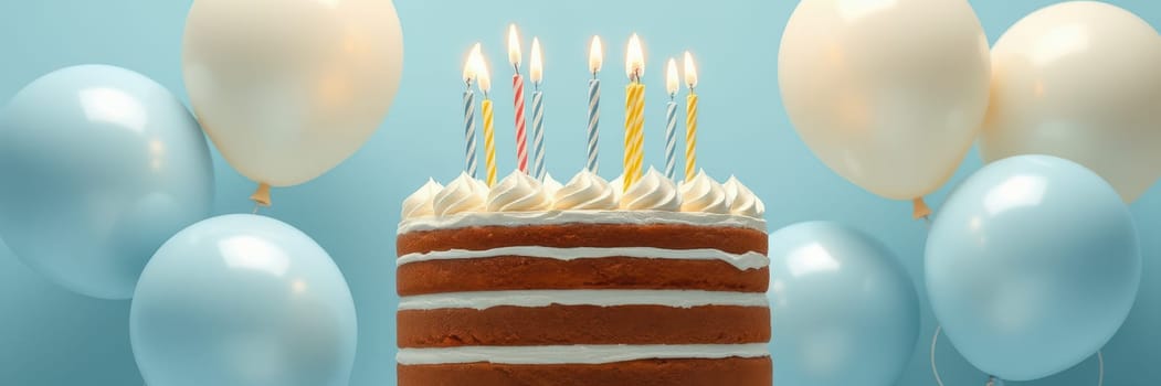 A beautifully decorated cake with seven lit candles sits at the center. Soft blue balloons are floating nearby, creating a festive atmosphere for a birthday celebration.