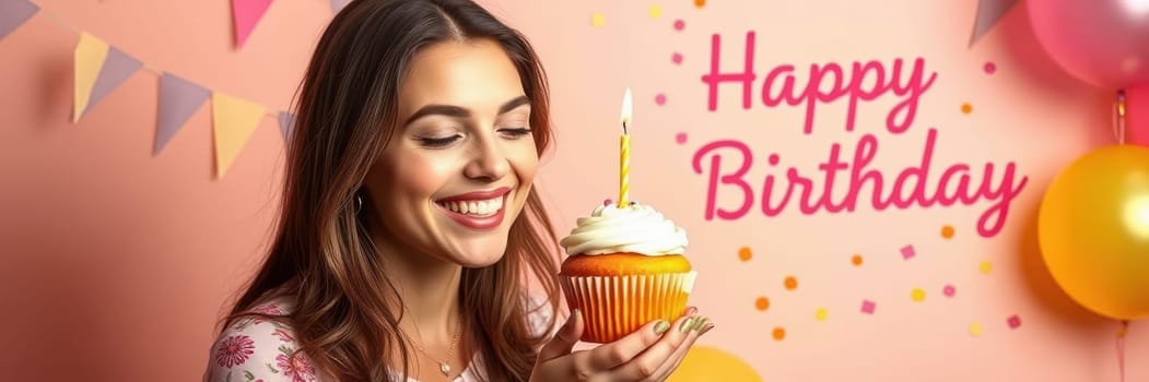 A young woman holds a decorated cupcake with a lit candle, smiling joyfully in front of a colorful birthday backdrop with cheerful decorations and a Happy Birthday message.