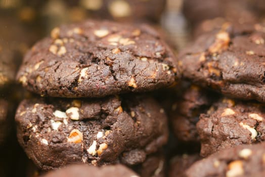 Decadent chocolate cookies stacked high, with nuts and rich chocolate chunks for indulgence