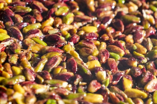 A detailed close-up of various fresh pistachios showcasing their natural colors and textures.