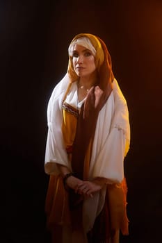 A girl is dressed in stylized national clothing, embodying Rebekah from the Christian Bible in an artistic setting.