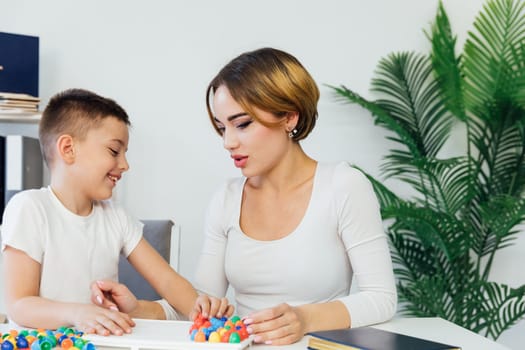 Teacher Playing Educational Games With Boy