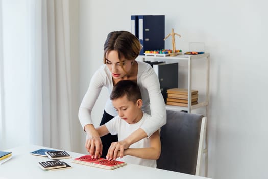 Teacher Playing Educational Games With Boy