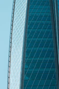 A stunning closeup view of a towering skyscrapers reflective glass facade, beautifully showcasing modern architecture