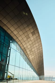 A stunning and modern building facade that showcases sleek lines along with elegant glass reflections and designs