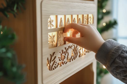 A hand of kid open wooden advent calendar for Christmas