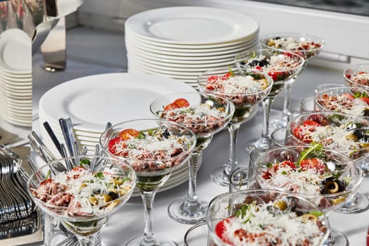 Stylish salad servings presented in elegant glasses, making them perfect for catering events or special gatherings