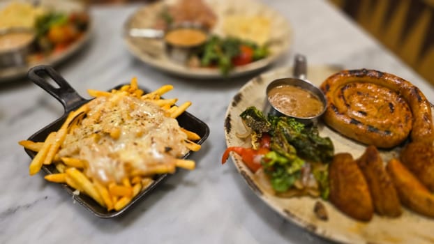 mouthwatering German worst curled up cumberland sausage meal featuring a grilled sausage, loaded cheese fries, and fresh vegetables served on a rustic plate. Perfect for dinner lovers appreciating hearty and flavorful dishes.