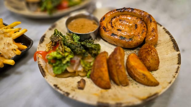 mouthwatering German worst curled up cumberland sausage meal featuring a grilled sausage, loaded cheese fries, and fresh vegetables served on a rustic plate. Perfect for dinner lovers appreciating hearty and flavorful dishes.