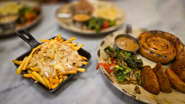 mouthwatering German worst curled up cumberland sausage meal featuring a grilled sausage, loaded cheese fries, and fresh vegetables served on a rustic plate. Perfect for dinner lovers appreciating hearty and flavorful dishes.