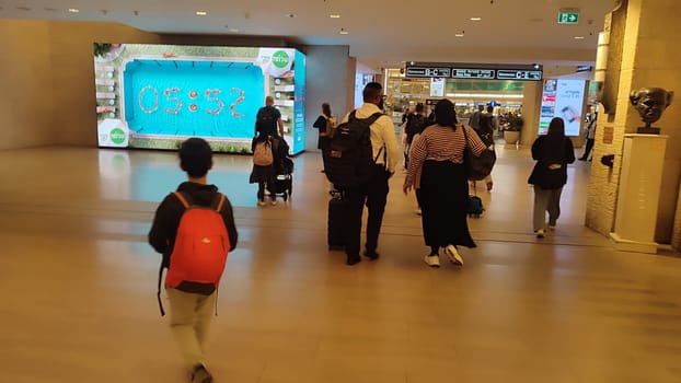 15 October 2024 Tel-Aviv Israel Ben Gurion airport Terminal 3, tourist lounge, screen clock, children. High quality editorial photo