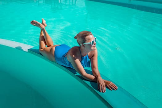 Bikini-clad woman enjoys poolside relaxation. Poolside ambiance. Capturing woman's relaxed time near pool
