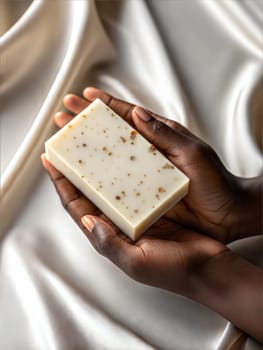 Hands holding piece of natural soap on satin background. Handmaid exfoliant soap sugar. Skin treatment concept. Ai generated image