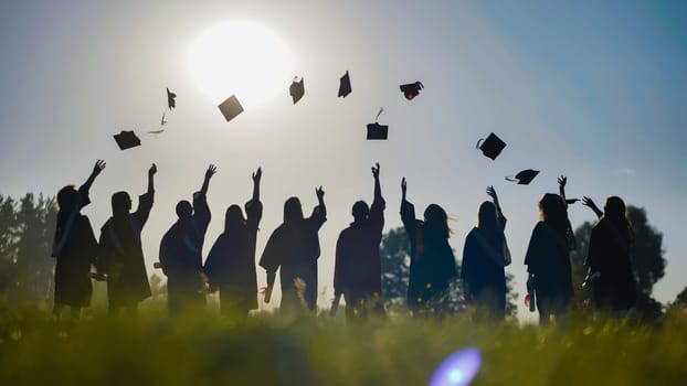 Graduates are celebrating throwing their graduation caps in the air.