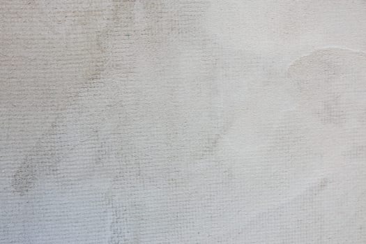 Close-up photo of old plaster on a concrete wall.