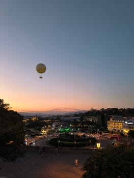 17 August 2024 Tbilisi Georgia, night city landscape, peace bridge, sky, hot air balloon, sunset. High quality photo
