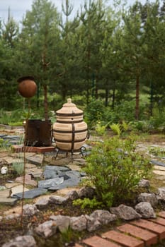 A peaceful and tranquil outdoor space that features unique and artistic garden decor along with lush greenery