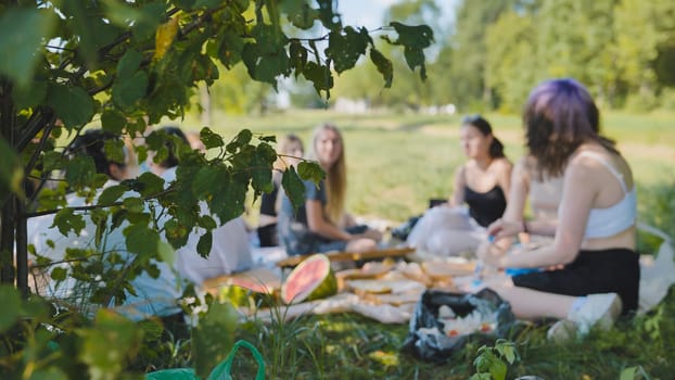 School children had a picnic under the tree with fruit and food. Blurred concept