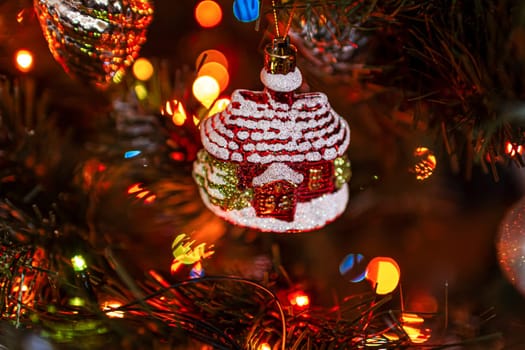 Beautiful festive decorations on the Christmas tree. Close-up. Beautiful Christmas background. The concept of decorations and decor for the new year. New Year's Card 2025. High quality photo