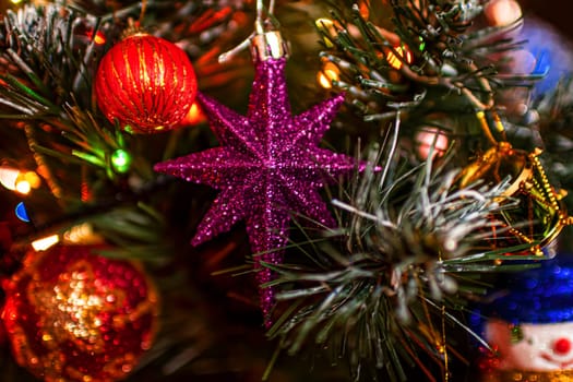Beautiful festive decorations on the Christmas tree. Close-up. Beautiful Christmas background. The concept of decorations and decor for the new year. New Year's Card 2025. High quality photo