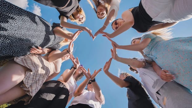 Schoolchildren make a heart shape with their hands