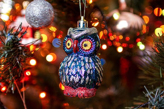 Beautiful festive decorations on the Christmas tree. Close-up. Beautiful Christmas background. The concept of decorations and decor for the new year. New Year's Card 2025. High quality photo