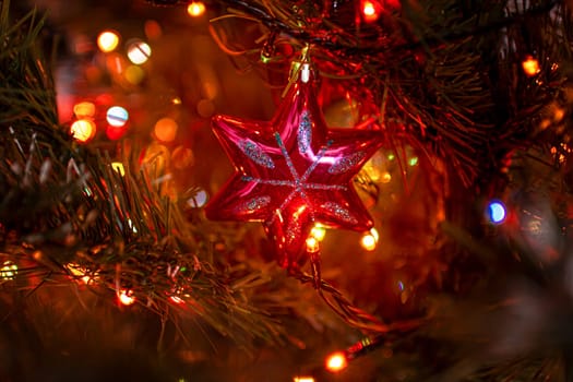 Beautiful festive decorations on the Christmas tree. Close-up. Beautiful Christmas background. The concept of decorations and decor for the new year. New Year's Card 2025. High quality photo