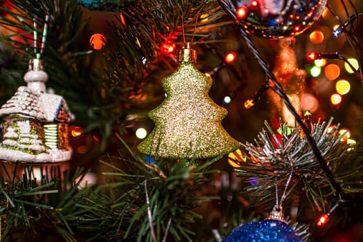 Beautiful festive decorations on the Christmas tree. Close-up. Beautiful Christmas background. The concept of decorations and decor for the new year. New Year's Card 2025. High quality photo