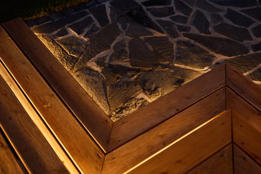 A stunning wood and stone corner design artfully illuminated with a warm and inviting light for ambiance