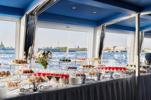 An exquisite buffet setup featuring a variety of gourmet dishes and stunning views of the water nearby