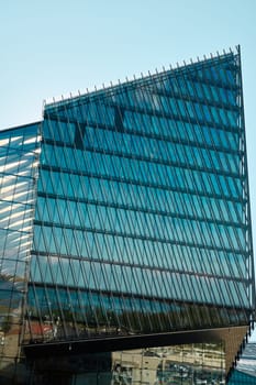 This impressive building showcases an innovative glass design with striking angles and captivating details