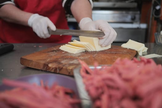 In a busy kitchen, the chef prepares ingredients with precision for quality cooking and dishes