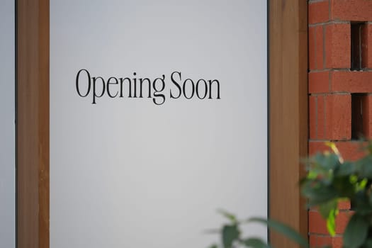 A chic and stylish Opening Soon sign beautifully displayed on a storefront window