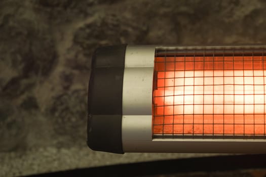 Modern electric infrared heater in living room, closeup. High quality photo