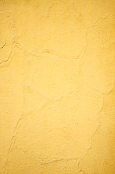 A vibrant yellow wall texture ideal for backgrounds and graphic designs for creativity
