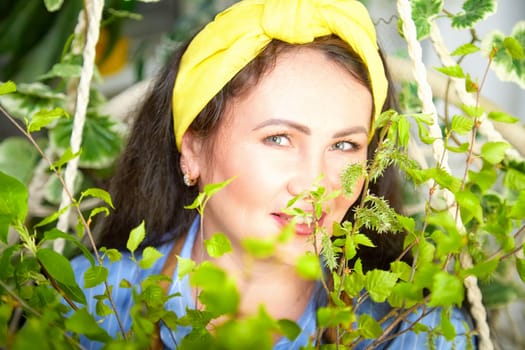 A dedicated gardener cares for thriving plants while enjoying her greenhouse sanctuary.
