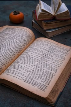 Close-up of several old dictionaries against a dark background. Selective focus.