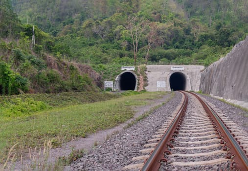 Saraburi, Thailand - Mar 20, 2022 - The entrance of Railroad and Railway tunnel through the Mountain surrounded by nature at Khao phra phutthachai. use it as your Wallpaper, Poster and Space for text, Selective focus.
