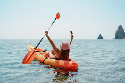 Kayak sea woman. Happy attractive woman with long hair in red swimsuit, swimming on kayak. Summer holiday vacation and travel concept