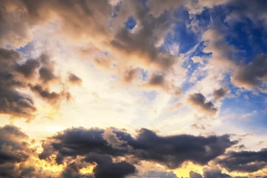 cloudy sky with clouds at sunset. Background of the orange blue sky at sunrise