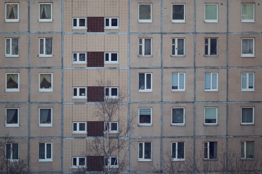 Closeup of a multistory apartment building showcasing its welldesigned windows and unique architecture