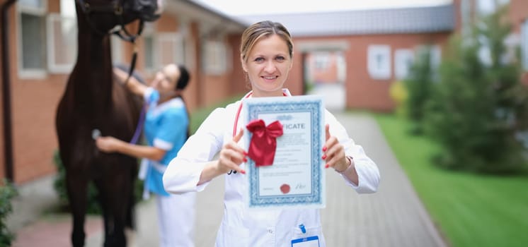 Veterinarian shows the certificate of the horse, close-up, blurry. Expert opinion of a veterinarian. Horse breeding, sports