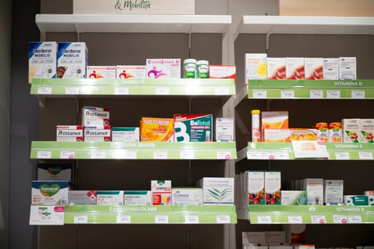 Cremona, Italy - November 20th 2024 Shelves stocked with a variety of medications and supplements in a pharmacy, offering healthcare solutions for different needs