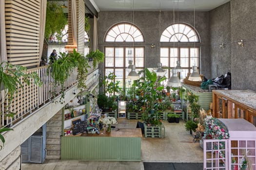 A vibrant indoor plant shop that showcases a diverse range of greenery along with charming decor elements